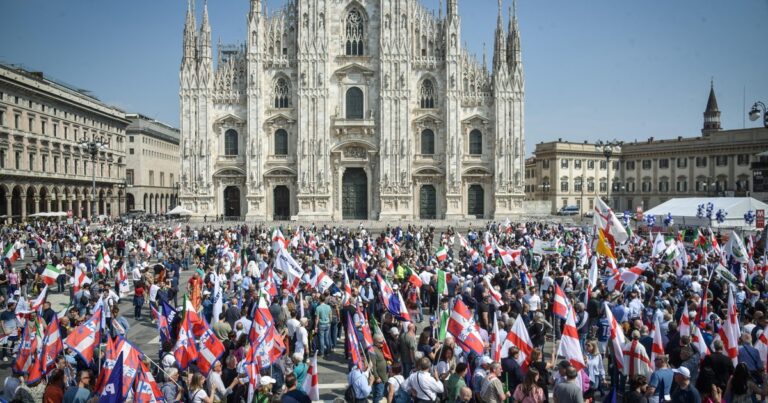 Agrupación de personas y dirigentes políticos en un acto en la Piazza del Duomo de Milán, Italia.